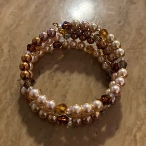 An new wrap bracelet with brown, gold and bronze beads.